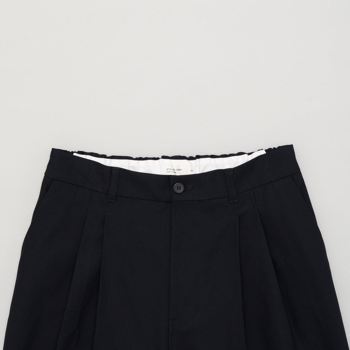 STILL BY HAND Deep Tucked Pressed Pants | Black Navy LEO BOUTIQUE